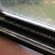 A streaked, dirty window and windowsill in the Winston-Salem Airbnb.